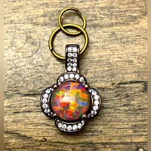 5/$25 Pendant in black enamel with mother of pearl-like stone and diamonds